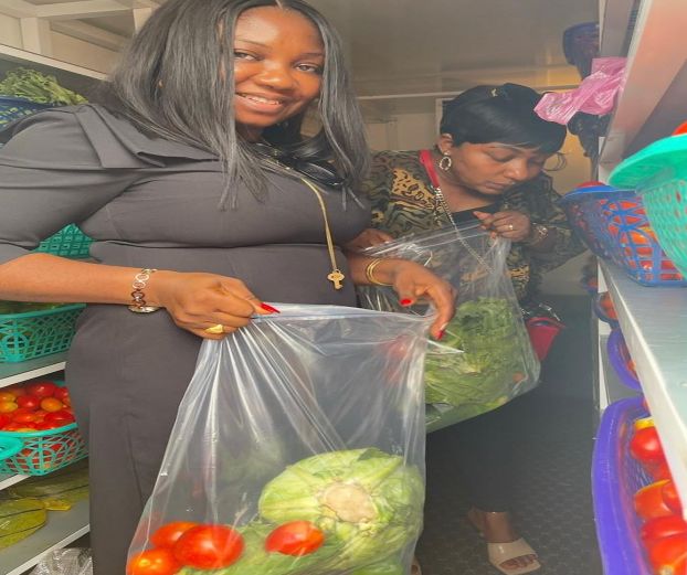 Customers bagging fresh vegetables from the cold room