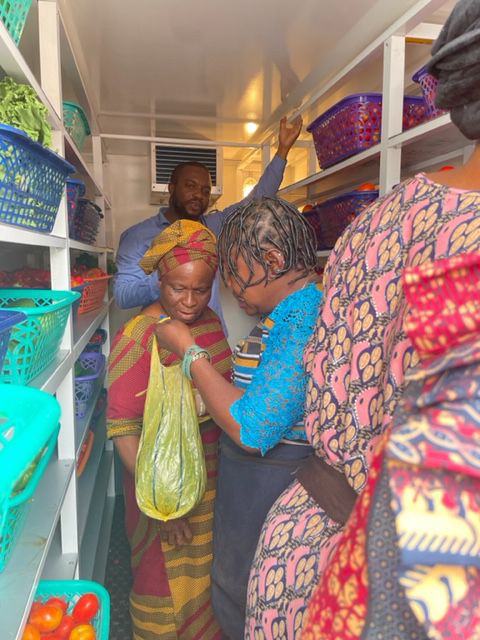 Market women collecting produce inside the SOLTECH cold room