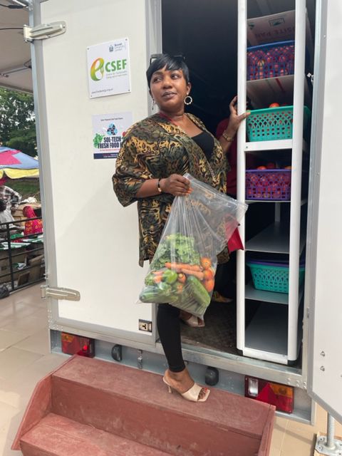 A customer leaving the SOLTECH cold room with a bag of fresh vegetables
